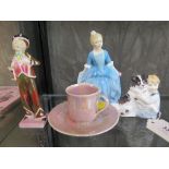 A Ruskin pink lustre glaze coffee can and saucer, and three Royal Doulton figures: Pearly Boy HN