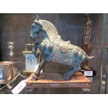 A Chinese bronze figure of a Tang horse, with one hoof raised, 21 cm high