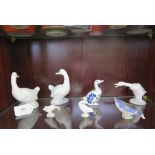 Two Nao figures of white geese looking back, a Lladro long neck goose and four other bird