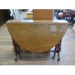 A Victorian walnut oval Sutherland table, with lyre supports joined by a turned stretcher, on scroll