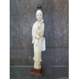 A Japanese ivory Okimono, of a young girl playing hand bells, circa 1910, 19 cm high