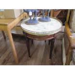 A French Regence style mahogany and brass mounted side table, the circular marble top over a