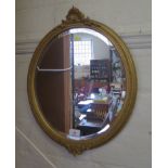 A small oval giltwood wall mirror, the beaded and guilloche frame mounted with shell and foliate