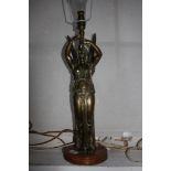 A late Victorian gilt metal table lamp, in the form of an angel holding aloft the light, on a timber