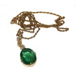 A large emerald and diamond pendant on gold neck chain