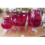 A set of four Whitefriars red glass graduated drape vases, largest 28 cm high, two brandy glass