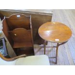 A mahogany oval folding table with trestle support, 42 cm wide and a magazine rack (2)