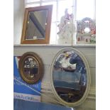 A giltwood framed long wall mirror, 129 cm high, a velvet moulded frame mirror, and two oval mirrors