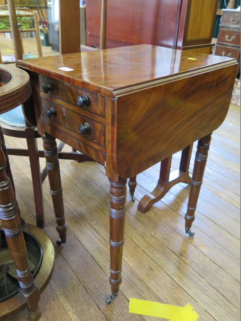 A Regency crossbanded mahogany Pembroke table, the hinged top over two frieze drawers on ring turned