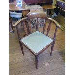 An Edwardian inlaid mahogany corner chair, with fleur de lys motif, on ring turned tapering legs