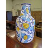 An Italian slip glazed vase, depicting birds among flowering foliage in blue and yellow, signed near