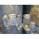 Seven silver lidded glass toilet bottles and a silver goblet