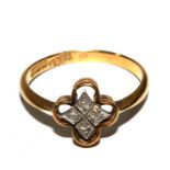 An 18 carat gold ring set with four small diamonds