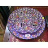 A Turkish profusely hand enamelled floral design Hors d'Ouvres dish with seven sections, 36 cm