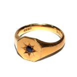 An 18 carat gold gentleman's signet ring set with a small sapphire