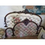 A Victorian mahogany bed head, the arched frame with foliate spray centre and button back