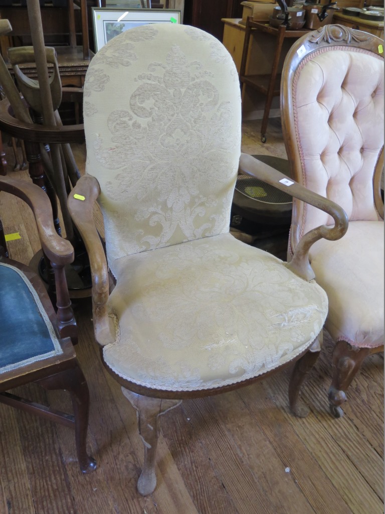 A George II style upholstered mahogany armchair with shepherd's crook arms and cabriole legs with