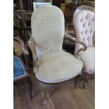 A George II style upholstered mahogany armchair with shepherd's crook arms and cabriole legs with