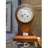 An Edwardian inlaid mahogany balloon mantel clock, the case with central patera, on brass ogee feet,