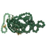 A green bead necklace and two green bead bracelets (possibly) jade