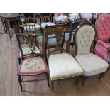 A Victorian rosewood nursing chair, with foliate carved top rail and moulded cabriole legs with