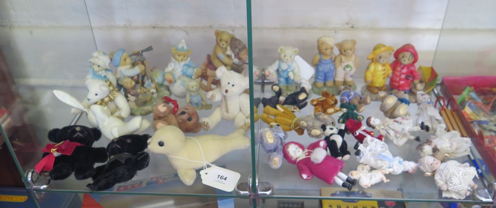 Two Hermann bear brooches, miniature bears, sea lion, ceramic bears and seven small bisque dolls