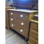 An Edwardian pine chest of drawers with two short and two long drawers, with ceramic handles and