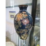 A Japanese Shippo enamel vase, the floral sprays on a dark blue ground, 17.5 cm high