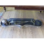 A Victorian polished steel shaped fire fender, 136 cm wide, with brass floral attachments and a pair