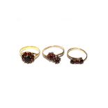 A collection of three garnet rings set in 9 carat gold