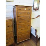 A 1930s oak tallboy, with seven graduated drawers, on cabriole legs, 61 cm wide,138 cm high