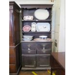 A stained oak dresser and rack, the two shelves over four short drawers and a pair of cupboard