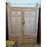 A 19th century pine kitchen cupboard, the pair of panelled doors enclosing shaped shelves, over four