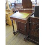An Edwardian mahogany Davenport desk, the hinged top enclosing compartments, over a leather lined