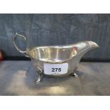 A silver gravy boat on three pad feet, Birmingham 1933