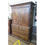 A George III inlaid oak linen press, the foliate inlaid frieze over a pair of oval panelled doors