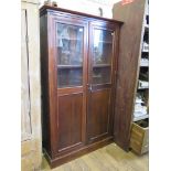 A mahogany bookcase, with twin glazed and panelled doors, 101 cm wide, 30 cm deep, 168 cm high