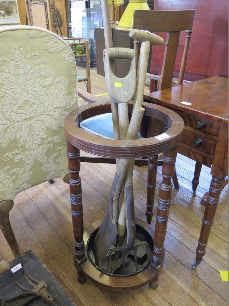 An Edwardian mahogany umbrella stand, cylindrical with ring turned supports, 37 cm diameter, 70 cm