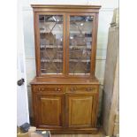 An Edwardian mahogany and satinwood crossbanded bookcase cabinet, the inlaid dentil cornice over a