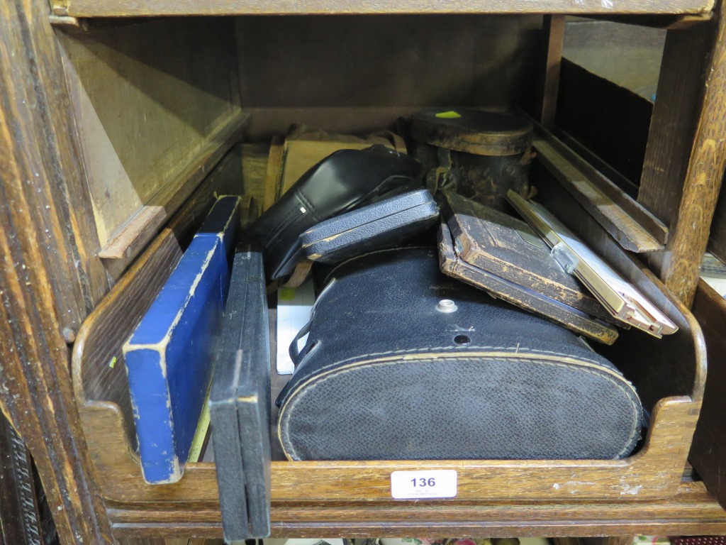 A pair of blacked brass binoculars, in a leather case, a pair of racing binoculars, a Box Brownie,