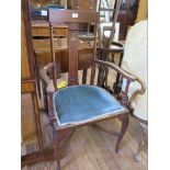 An Edwardian Art Nouveau style open armchair, with inlaid foliate design splat, on cabriole legs