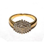 A diamond cluster ring set in 18 carat yellow gold