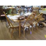 An Ercol light elm rectangular dining table and four Windsor dining chairs, table 152 x 76 cm,