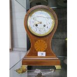 An Edwardian inlaid mahogany balloon mantel clock, the case with central patera, on brass ogee feet,