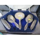 A cased five piece ladies silver dressing table set