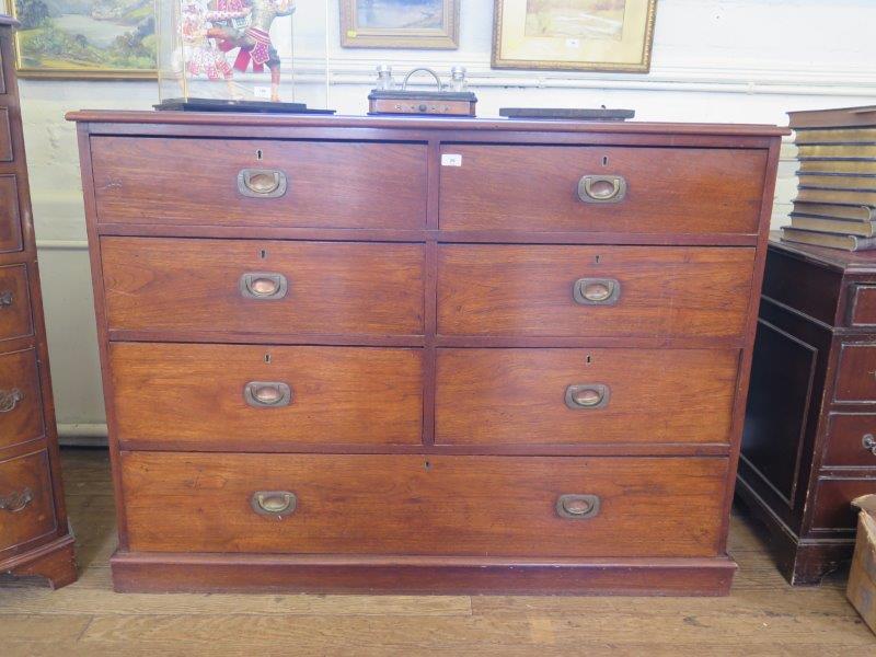 A large 19th Century chest of drawers, possibly teak, with six short drawers over a long drawer on a