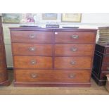 A large 19th Century chest of drawers, possibly teak, with six short drawers over a long drawer on a