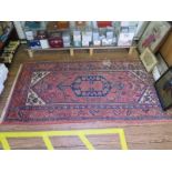 A Kazak rug, the blue pole medallion on a red field with ivory spandrels within a geometric leaf