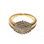 A diamond cluster ring set in 18 carat yellow gold