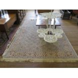 A Persian style carpet, with repeat herati and floral motif on an ivory field and foliate border,